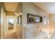 Upstairs hallway with neutral tones, decorative mirror, and views to other rooms at 45176 W Alamendras St, Maricopa, AZ 85139