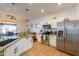 Modern kitchen features granite counters, stainless appliances, and view into the adjacent dining area at 45176 W Alamendras St, Maricopa, AZ 85139