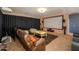 Cozy living room boasts comfortable seating, a projector, and a large screen for entertainment at 45176 W Alamendras St, Maricopa, AZ 85139
