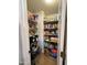 Well-stocked pantry with multiple shelves, providing ample storage space for food and household items at 45176 W Alamendras St, Maricopa, AZ 85139