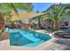 Inviting backyard pool surrounded by palm trees, lounge chairs, and ample shade, ideal for relaxation at 45176 W Alamendras St, Maricopa, AZ 85139