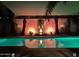 Relaxing pool area featuring palm trees, decorative lighting and serene water features at 45176 W Alamendras St, Maricopa, AZ 85139