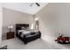Bedroom with vaulted ceiling, ceiling fan, carpet, and a motorcycle toy at 5140 S Tanglewood Dr, Chandler, AZ 85248