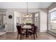 Dining room with modern chandelier, hard floors, and lots of natural light at 5140 S Tanglewood Dr, Chandler, AZ 85248