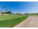 Lush golf course view with meticulously manicured greens, water feature, and clear blue sky at 5140 S Tanglewood Dr, Chandler, AZ 85248