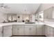 Spacious kitchen with quartz countertops, light-gray cabinets, stainless cooktop, and open to the dining area at 5140 S Tanglewood Dr, Chandler, AZ 85248