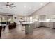 Open kitchen and living area with vaulted ceilings, recessed lighting, and large island at 5140 S Tanglewood Dr, Chandler, AZ 85248