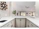Bright kitchen featuring white countertops, light-gray cabinets, and stainless steel sink, open to living space at 5140 S Tanglewood Dr, Chandler, AZ 85248