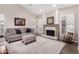 Comfortable living room with fireplace, plantation shutters and neutral decor at 5140 S Tanglewood Dr, Chandler, AZ 85248