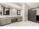 Neutral-toned main bathroom with double sinks, vanity, modern lighting, and a glass block shower stall at 5140 S Tanglewood Dr, Chandler, AZ 85248