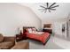 Bright main bedroom with a ceiling fan, a sitting area, and an ensuite bathroom through an archway at 5140 S Tanglewood Dr, Chandler, AZ 85248