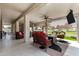 Spacious covered patio featuring an outdoor tv, comfortable seating, and beautiful golf course views at 5140 S Tanglewood Dr, Chandler, AZ 85248