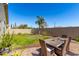 Backyard with a green lawn, brick patio with dining table and chairs at 5259 S Hadron --, Mesa, AZ 85212