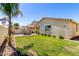 Well-maintained backyard features a green lawn, brick patio, and outdoor dining set at 5259 S Hadron --, Mesa, AZ 85212