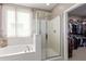 This bright bathroom features a garden tub, glass enclosed shower, and convenient access to the walk-in closet at 5259 S Hadron --, Mesa, AZ 85212
