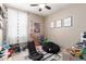 Fun and comfortable, this bedroom showcases a game-themed design, gaming chair, and dark-out curtains at 5259 S Hadron --, Mesa, AZ 85212