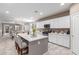 Open concept kitchen with an island, white cabinetry, and seamlessly connected to the dining area at 5259 S Hadron --, Mesa, AZ 85212