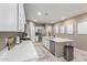 Bright kitchen features white cabinets, stainless steel appliances, and a large island with seating at 5259 S Hadron --, Mesa, AZ 85212