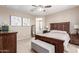 This main bedroom is complete with dark wood furnishings, neutral walls, and walk-in closet at 5259 S Hadron --, Mesa, AZ 85212