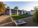 Spacious backyard showcasing a covered patio, well-maintained lawn, and cozy outdoor lounge area at 536 W Windsor Ave, Phoenix, AZ 85003