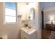 Bathroom featuring a sink, mirror, and window with natural light at 536 W Windsor Ave, Phoenix, AZ 85003
