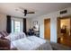Bright bedroom featuring two beds, ceiling fan and a door to the outside at 536 W Windsor Ave, Phoenix, AZ 85003