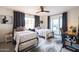 Bright bedroom featuring two beds, ceiling fan, stylish rug and a desk area next to a window at 536 W Windsor Ave, Phoenix, AZ 85003