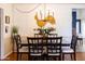 Traditional dining room with dark wooden table and chairs illuminated by a unique chandelier at 536 W Windsor Ave, Phoenix, AZ 85003
