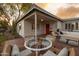 Charming front patio featuring outdoor dining and seating, complemented by mature trees and vibrant landscaping at 536 W Windsor Ave, Phoenix, AZ 85003