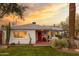 Beautiful home exterior with lush lawn, mature landscaping, and a quaint covered front porch at 536 W Windsor Ave, Phoenix, AZ 85003