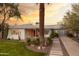 Inviting exterior showcasing a well-manicured lawn, desert landscaping, and a charming white brick home at 536 W Windsor Ave, Phoenix, AZ 85003