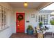 Charming covered front porch with vibrant red door, potted flowers and stylish outdoor seating at 536 W Windsor Ave, Phoenix, AZ 85003