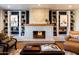 Bright living room with a decorative brick fireplace, custom built-ins, and comfortable furnishings at 536 W Windsor Ave, Phoenix, AZ 85003