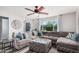 Bright living room with a large sectional couch and natural light from the large window at 8554 E Mcdonald Dr, Scottsdale, AZ 85250