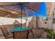 Brick patio featuring an umbrella-covered dining area, perfect for enjoying outdoor meals at 8554 E Mcdonald Dr, Scottsdale, AZ 85250