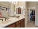Bathroom with double sinks, a walk-in closet and a shower behind sliding glass doors at 8661 E Ivy St, Mesa, AZ 85207