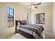 Bright bedroom featuring a ceiling fan, tiled floor and three large windows at 8661 E Ivy St, Mesa, AZ 85207