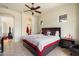 Comfortable bedroom with ensuite bathroom, ceiling fan, and neutral color palette at 8661 E Ivy St, Mesa, AZ 85207