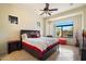 Comfortable bedroom featuring large window and natural light with decorative ceiling fan at 8661 E Ivy St, Mesa, AZ 85207