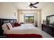 Well-lit bedroom with a large window and views of the outdoor landscape at 8661 E Ivy St, Mesa, AZ 85207