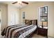 Cozy bedroom with large windows, closet, and nightstand with lamp at 8661 E Ivy St, Mesa, AZ 85207