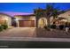 Charming home featuring a brick-accented facade, a paver driveway, and a well-maintained landscaped front yard at 8661 E Ivy St, Mesa, AZ 85207