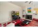 Comfortable living area with a television, modern decor, and a glimpse into an adjacent bedroom at 8661 E Ivy St, Mesa, AZ 85207