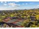 Aerial view of the community tennis courts nestled among lush greenery and offering stunning mountain views at 8661 E Ivy St, Mesa, AZ 85207