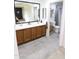 Bathroom featuring a double sink vanity, decorative mirror, toilet, and shower at 9732 N Penworth Dr, Casa Grande, AZ 85122