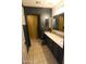 Bathroom featuring dark walls, modern vanity, and tiled floors at 9732 N Penworth Dr, Casa Grande, AZ 85122