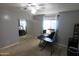 Bedroom featuring a ceiling fan, workstation, and mirrored closet at 9732 N Penworth Dr, Casa Grande, AZ 85122