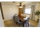 Dining room featuring a wooden table set with floral chairs, ceiling fan and a hutch at 9732 N Penworth Dr, Casa Grande, AZ 85122