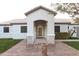 Inviting front entrance with decorative brickwork, comfortable seating, and well-maintained landscaping at 9732 N Penworth Dr, Casa Grande, AZ 85122