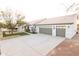 Spacious three-car garage with a concrete driveway, complemented by manicured landscaping at 9732 N Penworth Dr, Casa Grande, AZ 85122
